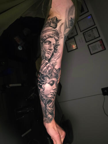 Black and gray realism sleeve tattoo healed work by Efren Tattoos Del Rio Texas