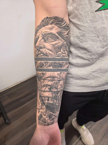 Black and gray realism forearm sleeve tattoo fully healed with existing arm bands by Efren Tattoos Del Rio Texas
